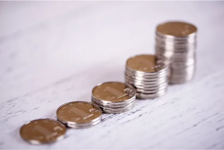 Stacks of coins growing taller from left to right